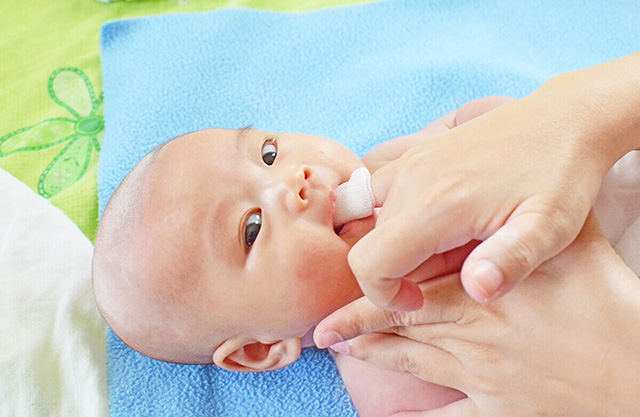 Nên vệ sinh lưỡi cho bé bằng nước muối sinh lý chuyên dụng cho trẻ sơ sinh